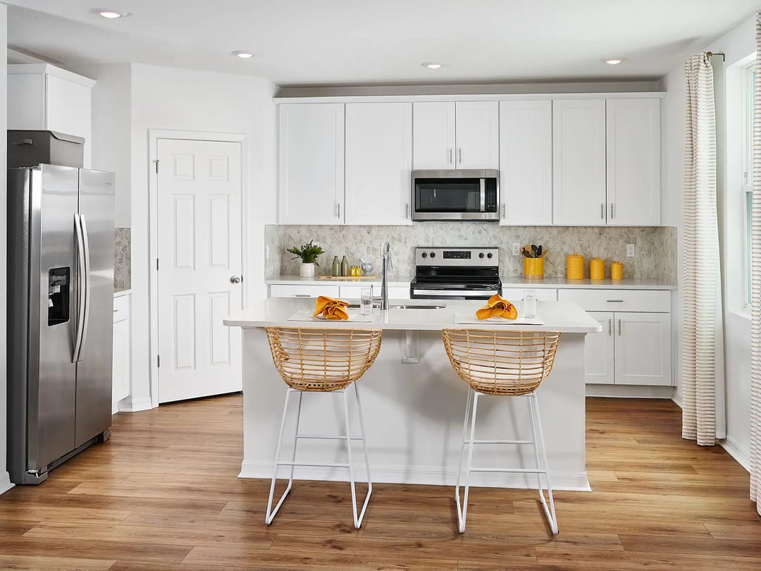 The Meadow at Crossprairie — Kitchen of the Primrose plan modeled at The Meadow at Crossprairie